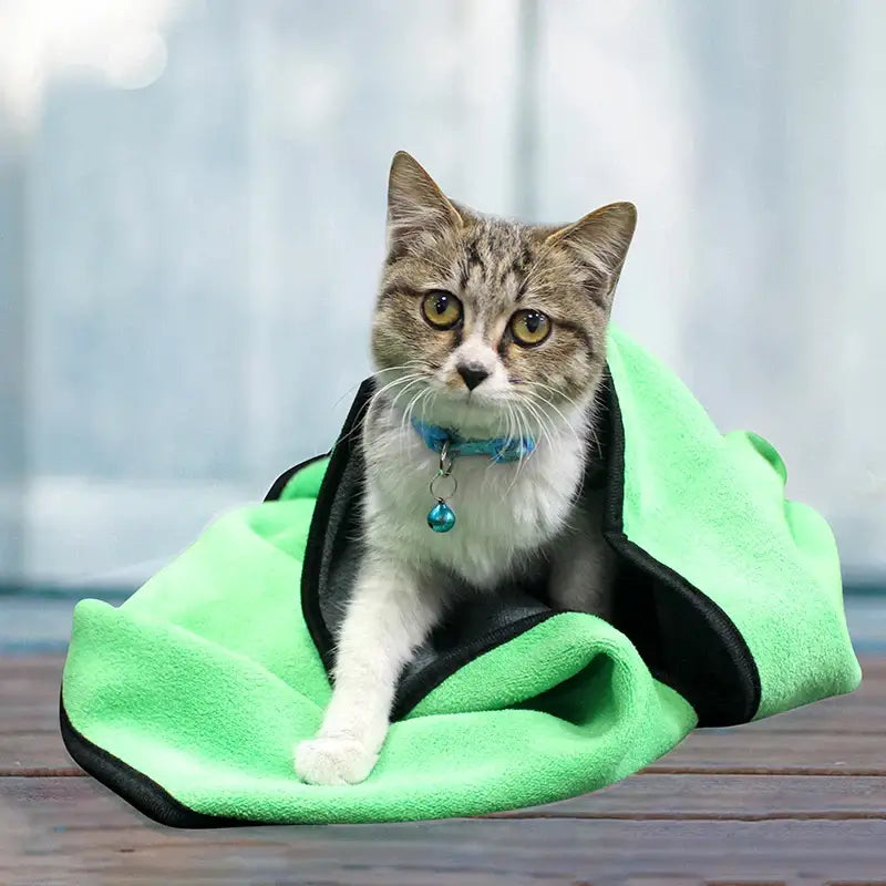 Quick-Drying Pet Bath Towel - Lint-Free in green wrapped around a cat. Soft, absorbent microfiber towel ideal for pet grooming and drying.