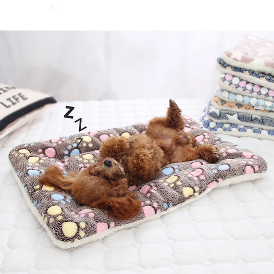 Soft Flannel Pet Bed Mat with colorful paw prints, featuring a small dog sleeping comfortably. Washable, cozy, and eco-friendly for cats and dogs.