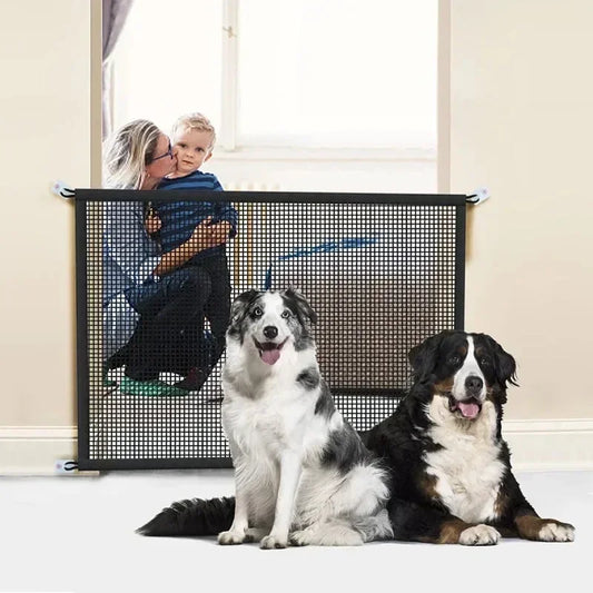 Mesh pet gate installed in doorway with two large dogs sitting in front, designed to maintain boundaries while allowing visibility and interaction.